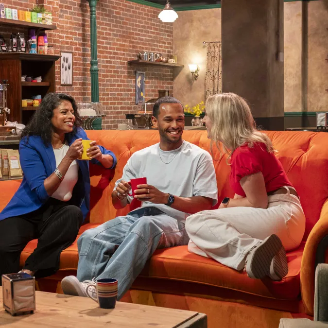 Three Friends on Orange Couch in Central Perk